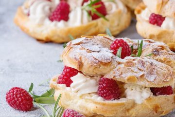 An almond croissant filled with cream and raspberries.